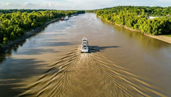 white and black boat on Mississipii river during daytime