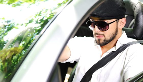 Young man driving a car with